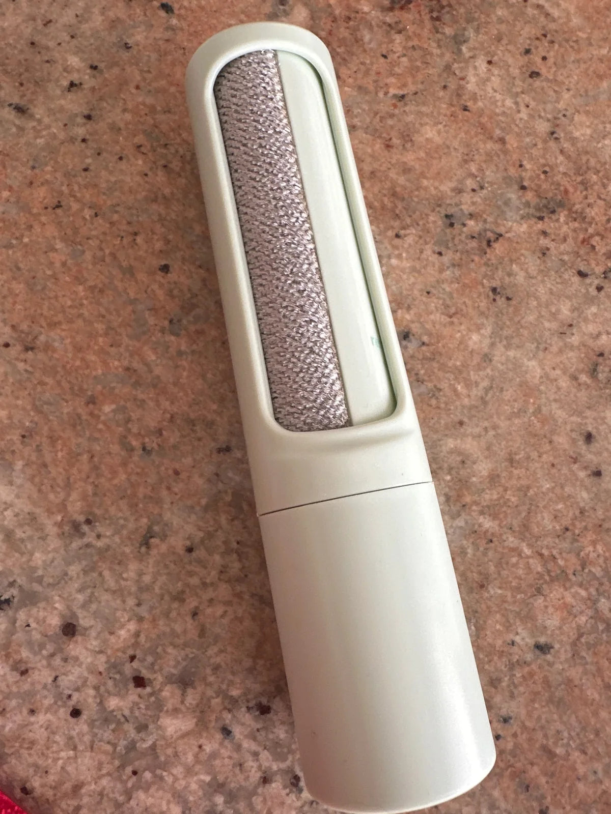 Customer photo of the green reusable brush and its directional fabric head